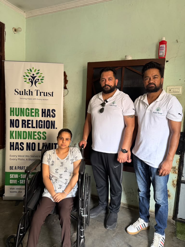 Sukh Trust team providing wheelchair support to a woman