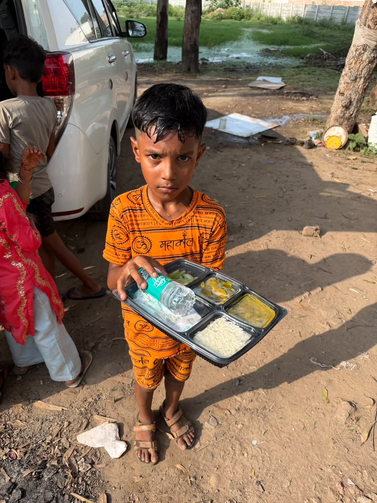 Young boy receiving fresh meal package and clean water