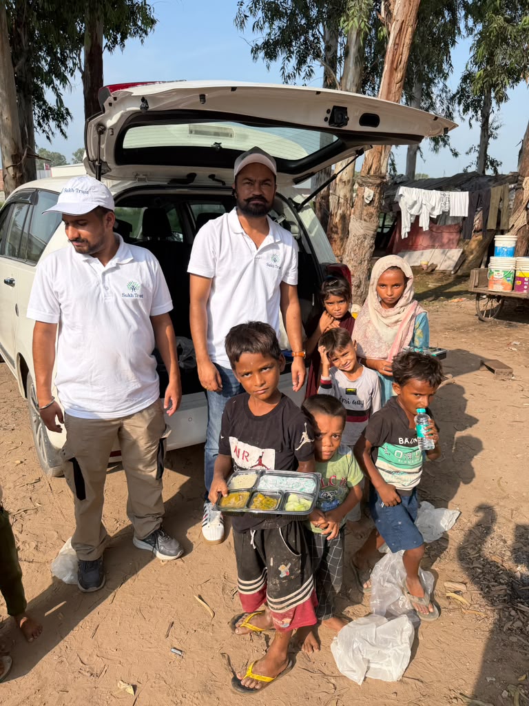 Sukh Trust volunteer team distributing meals directly to community children